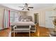 Spacious bedroom with hardwood floors, a ceiling fan, and a decorative bench at the foot of the bed at 111 Bethpage Rd, Kannapolis, NC 28081