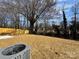 Home's backyard with yellow fence and newly laid mulch under a blue and partly cloudy sky at 1116 Kenly St, Salisbury, NC 28144