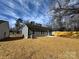 Home's backyard with grey siding, a concrete patio, and newly laid mulch in a residential area at 1116 Kenly St, Salisbury, NC 28144