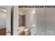 View of a bathroom including tub with tile surround, toilet and vanity with sink at 1116 Kenly St, Salisbury, NC 28144