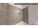 Close-up of the tiled tub and shower with built-in niche for storage at 1116 Kenly St, Salisbury, NC 28144