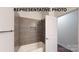 Tiled tub and shower with shower head and a built-in niche for storage in the bathroom at 1116 Kenly St, Salisbury, NC 28144