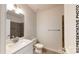 Modern bathroom with a white vanity, sink, toilet, and tiled walls in neutral tones at 1116 Kenly St, Salisbury, NC 28144