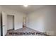 Bedroom with neutral carpet and two doors; one to the hall, one to the closet at 1116 Kenly St, Salisbury, NC 28144
