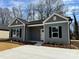Charming single-story home with gray siding, black shutters, and a well-manicured lawn at 1116 Kenly St, Salisbury, NC 28144