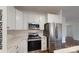 Modern kitchen featuring white cabinets, stainless steel appliances and marble countertops at 1116 Kenly St, Salisbury, NC 28144