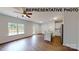Bright open-concept living space with a modern kitchen, wood floors and large windows at 1116 Kenly St, Salisbury, NC 28144