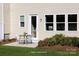 Inviting back patio with seating area, lush landscaping, and access to the backyard at 14722 Tamarack Dr, Charlotte, NC 28278