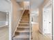 Bright entryway featuring a carpeted staircase and light wood-look flooring leading into an open floor plan at 1549 South Point Rd, Belmont, NC 28012