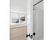 View of a bright bathroom with a glass-enclosed shower and a bedroom visible through a doorway with hardwood floors at 1641 Arlyn Cir # A, Charlotte, NC 28213