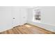 Bedroom with bright window, light wood-look floors, and two closets at 1641 Arlyn Cir # A, Charlotte, NC 28213