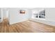 A spacious bedroom with wood-look flooring, ample natural light from the window, and a wall-mounted television at 1641 Arlyn Cir # A, Charlotte, NC 28213