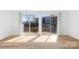 Bright living room with sliding glass doors and wood-look floors at 1641 Arlyn Cir # A, Charlotte, NC 28213