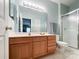 Updated bathroom with wooden vanity, ample counter space and enclosed walk-in shower at 17137 Red Feather Dr, Charlotte, NC 28277
