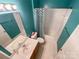 Bright teal bathroom featuring a shower-tub, vanity with sink and chevron pattern shower curtain at 17137 Red Feather Dr, Charlotte, NC 28277