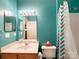 Bathroom featuring a turquoise wall color, wood vanity, and shower/tub combination at 17137 Red Feather Dr, Charlotte, NC 28277