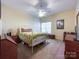 Comfortable bedroom featuring a ceiling fan, window, and neutral carpet at 17137 Red Feather Dr, Charlotte, NC 28277