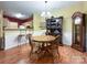 Dining area with hardwood floors, a wooden table, and a hutch with glass shelves at 17137 Red Feather Dr, Charlotte, NC 28277