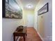 Entry hallway showcasing wood floors, a white front door, and decorative wall art at 17137 Red Feather Dr, Charlotte, NC 28277