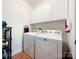 Laundry room with white cabinets and white washer and dryer units at 17137 Red Feather Dr, Charlotte, NC 28277