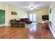 Living room with hardwood floors, a ceiling fan, and patio doors at 17137 Red Feather Dr, Charlotte, NC 28277