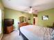 Spacious bedroom features a ceiling fan, dresser and walk-in closet access at 17137 Red Feather Dr, Charlotte, NC 28277