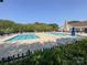 Community pool with lounge chairs and a clubhouse in the background at 17137 Red Feather Dr, Charlotte, NC 28277