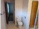 Toilet with white wainscotting in a bathroom with wood look flooring at 1807 Brantley Rd, Kannapolis, NC 28083