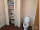 Functional bathroom space with a toilet, storage shelving and wood look flooring at 1807 Brantley Rd, Kannapolis, NC 28083