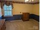 Bedroom with carpet, border wallpaper, blue wainscoting, window, and wooden dressers at 1807 Brantley Rd, Kannapolis, NC 28083