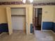 Carpeted bedroom with large closet, wallpaper border, blue wainscoting and doorway to hall at 1807 Brantley Rd, Kannapolis, NC 28083