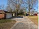 Long driveway leading to a garage with a basketball hoop, surrounded by mature trees at 1807 Brantley Rd, Kannapolis, NC 28083