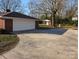 Long concrete driveway leading to an attached garage and backyard basketball court at 1807 Brantley Rd, Kannapolis, NC 28083