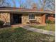 Charming front exterior with stone accents, a bench, and a well-maintained lawn at 1807 Brantley Rd, Kannapolis, NC 28083