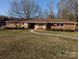 Charming single-story brick home with manicured lawn and stone accents at 1807 Brantley Rd, Kannapolis, NC 28083