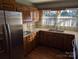 Traditional kitchen with wood cabinets, stainless steel appliances, and a double basin sink beneath window at 1807 Brantley Rd, Kannapolis, NC 28083