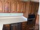 Kitchen with light countertops, stainless steel appliances and oak cabinets with stainless dishwasher and oven at 1807 Brantley Rd, Kannapolis, NC 28083