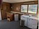 Functional laundry room with washer, dryer, sink, cabinets, and natural light at 1807 Brantley Rd, Kannapolis, NC 28083