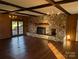 Cozy living room with a stone fireplace, exposed beams, and hardwood floors at 1807 Brantley Rd, Kannapolis, NC 28083