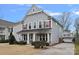 Charming two-story home features a manicured lawn, inviting front porch, and complementary exterior colors at 2005 Pinckney Ave, Charlotte, NC 28205