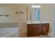 Bathroom featuring a double sink vanity and a large soaking tub at 2043 Covered Bridge Ct, Rock Hill, SC 29732