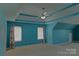 Large primary bedroom with tray ceiling, ceiling fan, and two windows at 2043 Covered Bridge Ct, Rock Hill, SC 29732
