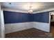 Dining room features modern lighting fixture, chair rail and wood flooring at 2043 Covered Bridge Ct, Rock Hill, SC 29732