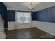 Dining room features modern lighting fixture, chair rail and wood flooring at 2043 Covered Bridge Ct, Rock Hill, SC 29732