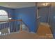 Bright hallway with carpeted floors, wooden staircase and trim, and a view to the entry at 2043 Covered Bridge Ct, Rock Hill, SC 29732