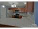 Kitchen with stainless steel appliances, wood cabinets, and speckled granite countertops at 2043 Covered Bridge Ct, Rock Hill, SC 29732