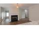 Living room showcasing a fireplace, hardwood flooring, and decorative light fixture at 2043 Covered Bridge Ct, Rock Hill, SC 29732