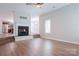 Open-concept living room with fireplace, hardwood floors, and seamless transition to the kitchen at 2043 Covered Bridge Ct, Rock Hill, SC 29732