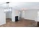 Bright living room features a cozy fireplace, modern light fixture, and hardwood flooring at 2043 Covered Bridge Ct, Rock Hill, SC 29732