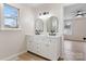 Bright bathroom featuring a double vanity, modern light fixture and black hardware at 4065 Lost Creek Ct, Hickory, NC 28602